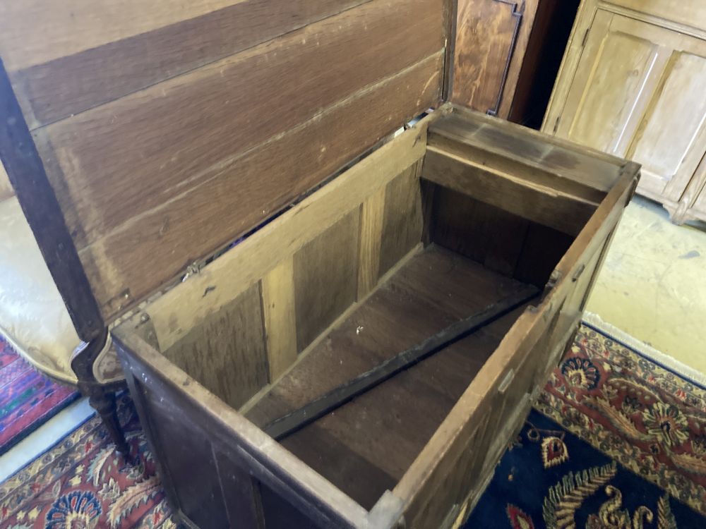 An 18th century panelled oak mule chest, width 118cm, depth 56cm, height 72cm